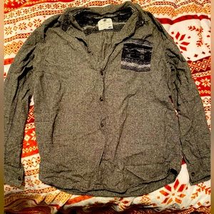 On the byas men’s button down shirt. Gray with design on pocket size X-Large.